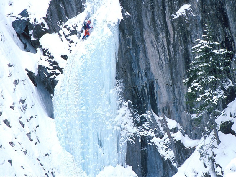 Ice climber on frozen waterfall