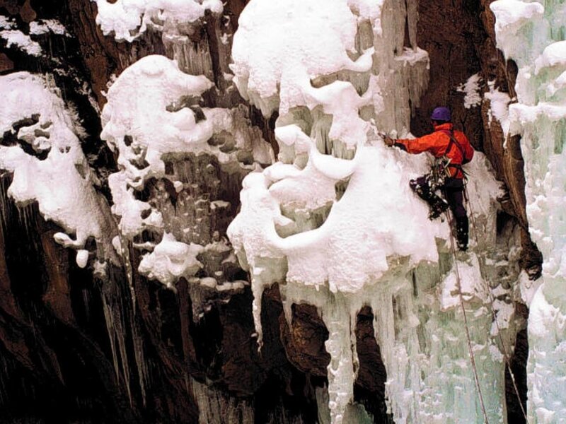 Ice climber on frozen waterfall