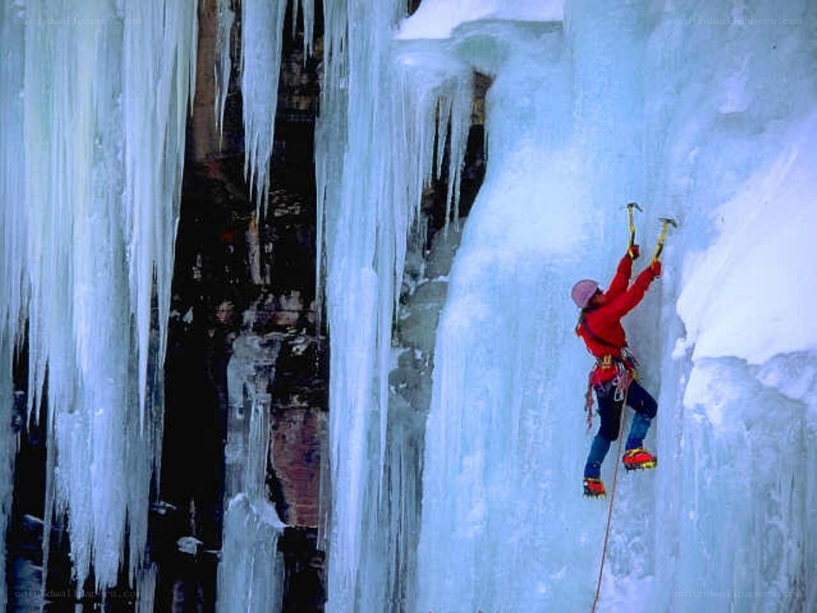Ice climber on frozen waterfall