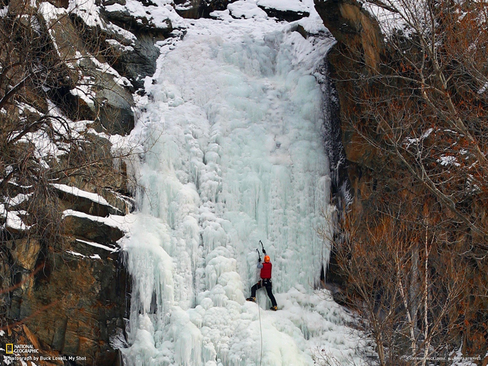 Ice climber on frozen waterfall