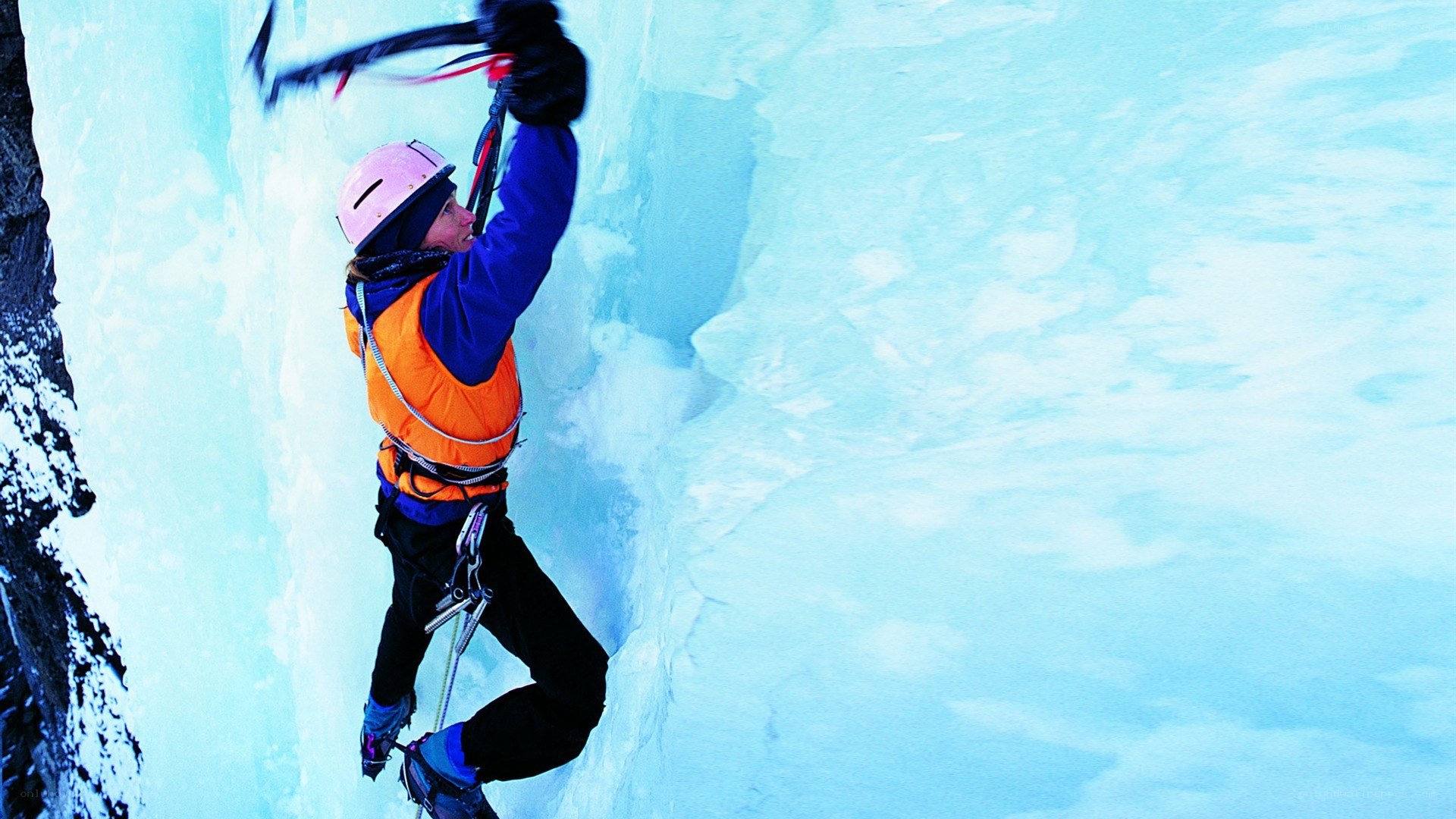 Ice climber scaling a frozen wall