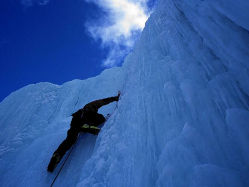 Ice climber scaling a frozen waterfall
