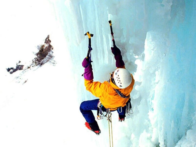 Ice climber scaling a frozen waterfall