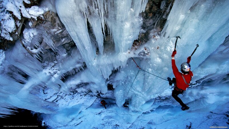 Ice climber scaling frozen waterfall
