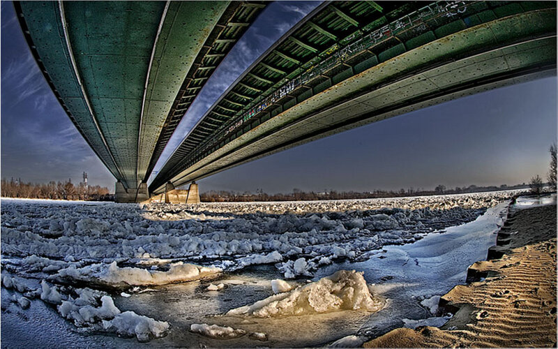 Ice-covered River under Bridge