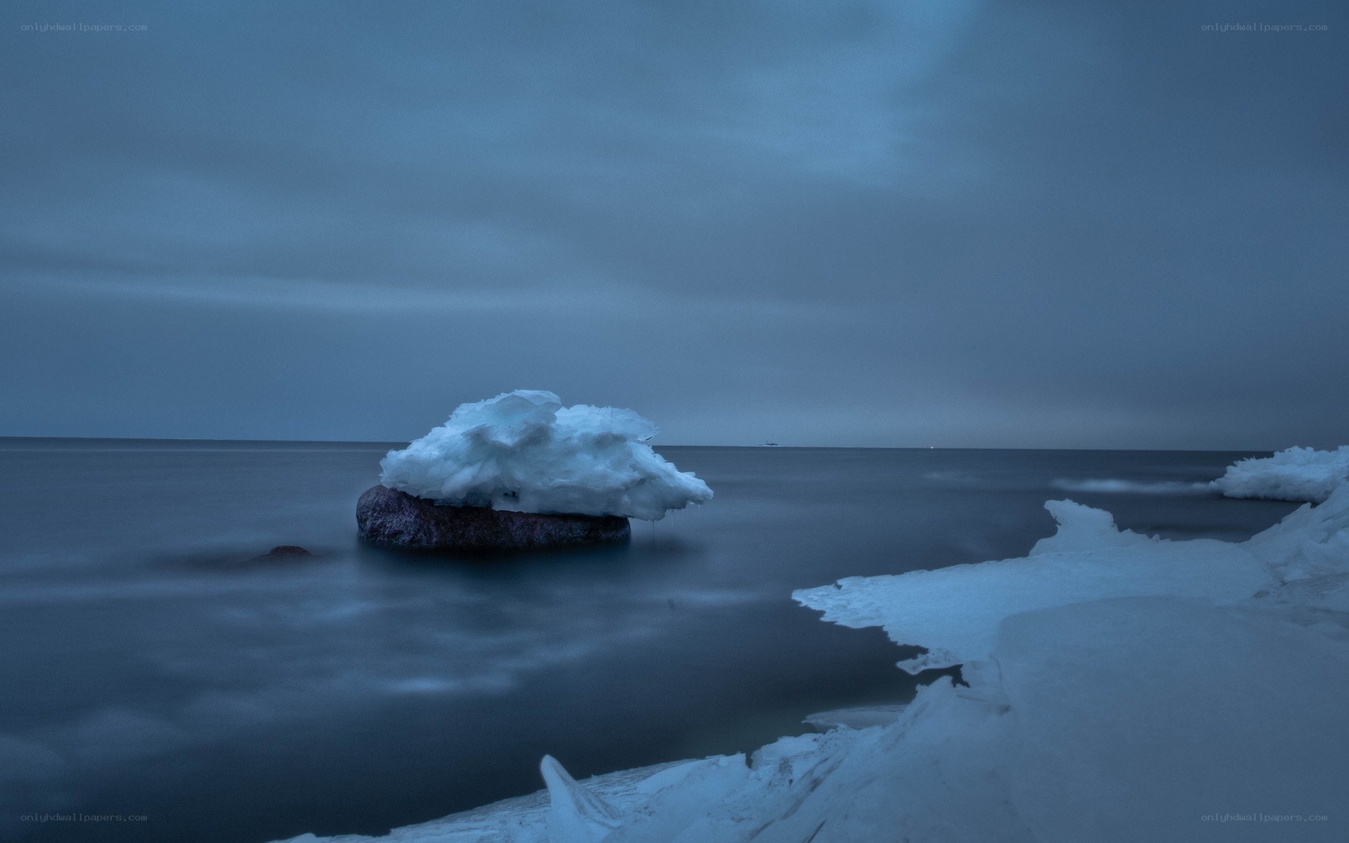 Ice-covered rock in calm sea