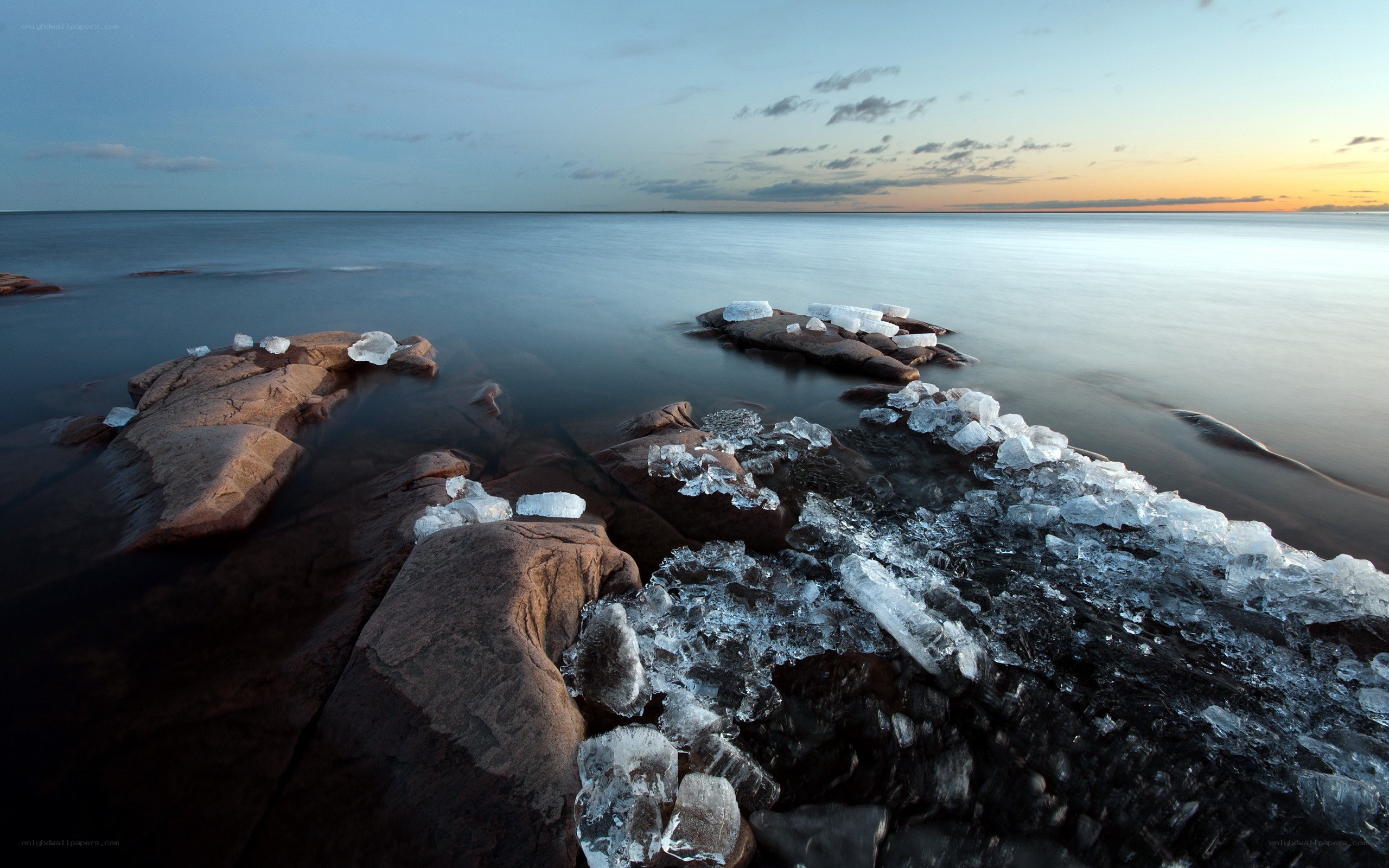 ice-covered rocks at sunset
