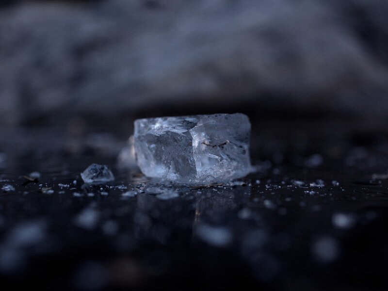 Ice Cube on Dark Surface — Black