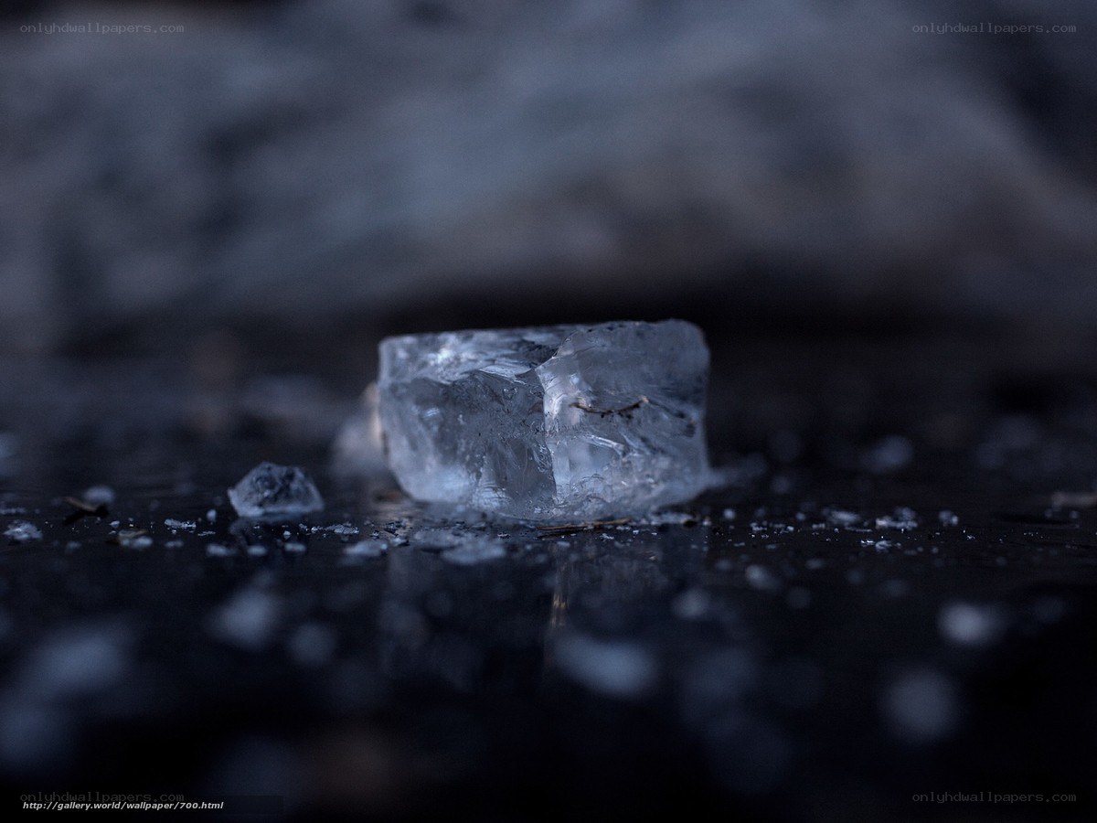 Ice cube on dark surface