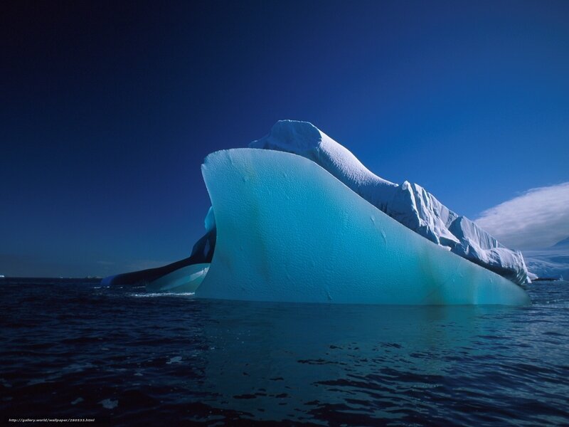Iceberg floating in blue water