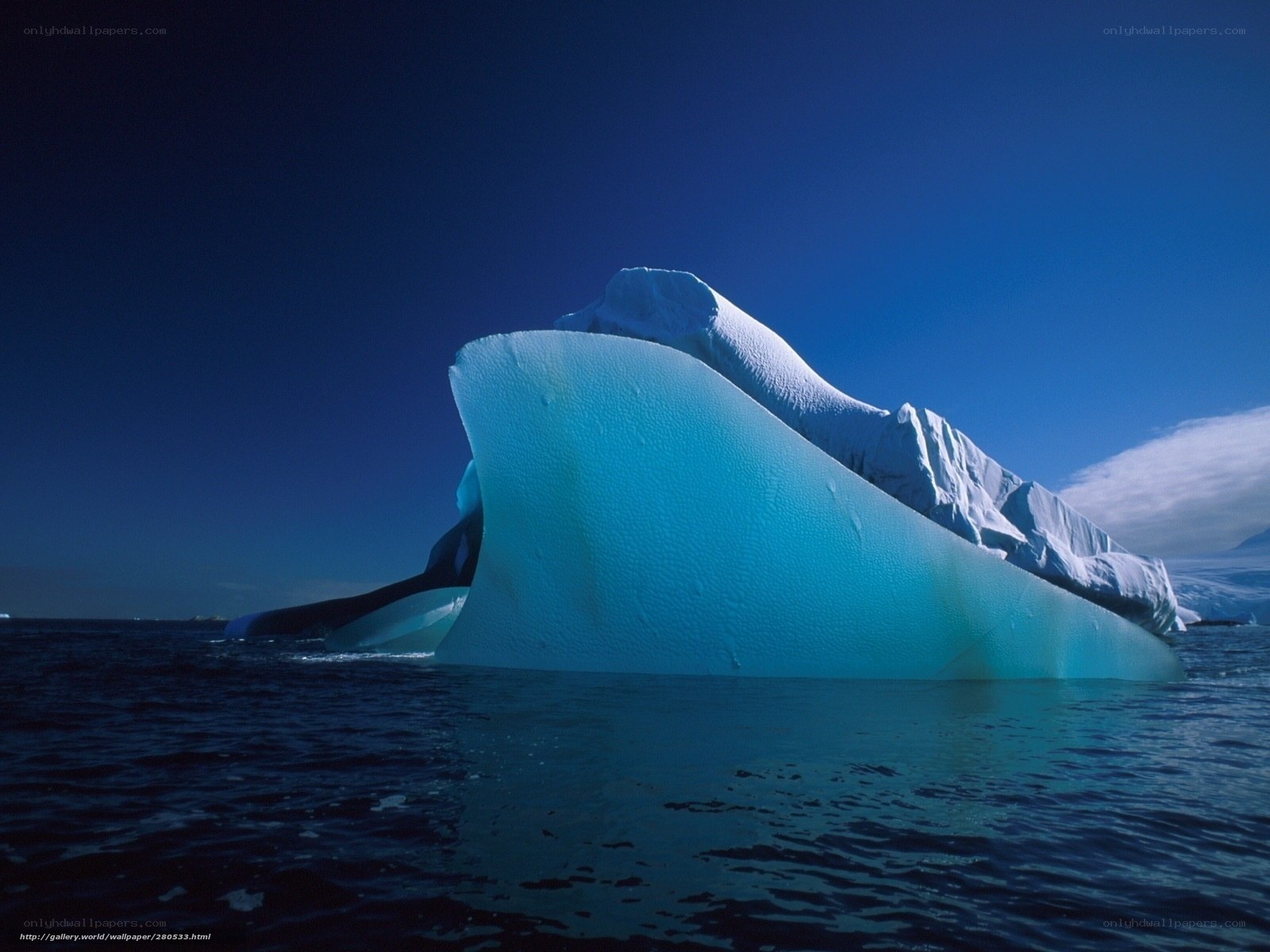 Iceberg floating in blue water