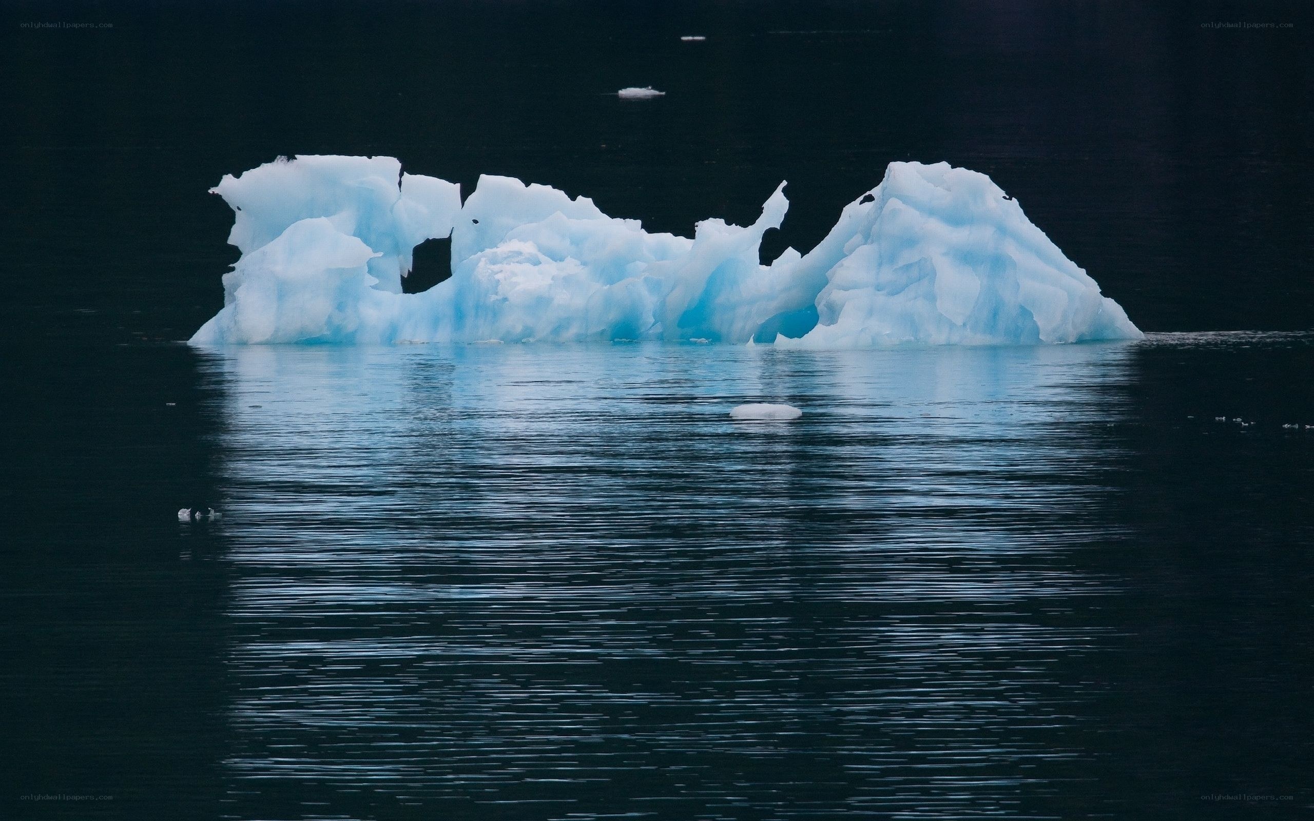 Iceberg floating in dark water