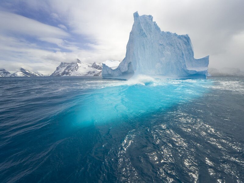 Iceberg in Ocean — Blue, Dramatic, Photograph, Mountains, Sky