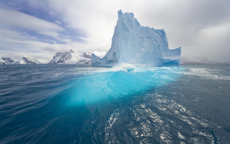 Iceberg in Ocean — Blue, Dramatic, Photograph, Mountains, Sky, White, Gray