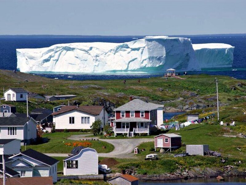 Iceberg Near Coastal Village — White