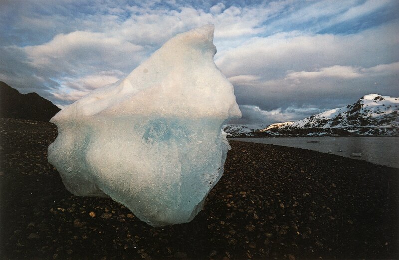Iceberg on a rocky shore