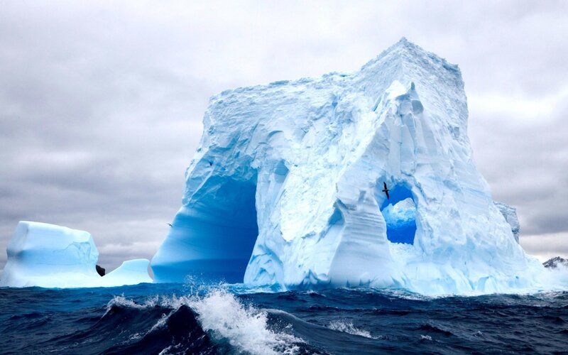 Iceberg with Arch — Blue, Dramatic, Photograph, Ocean, Bird, Clouds