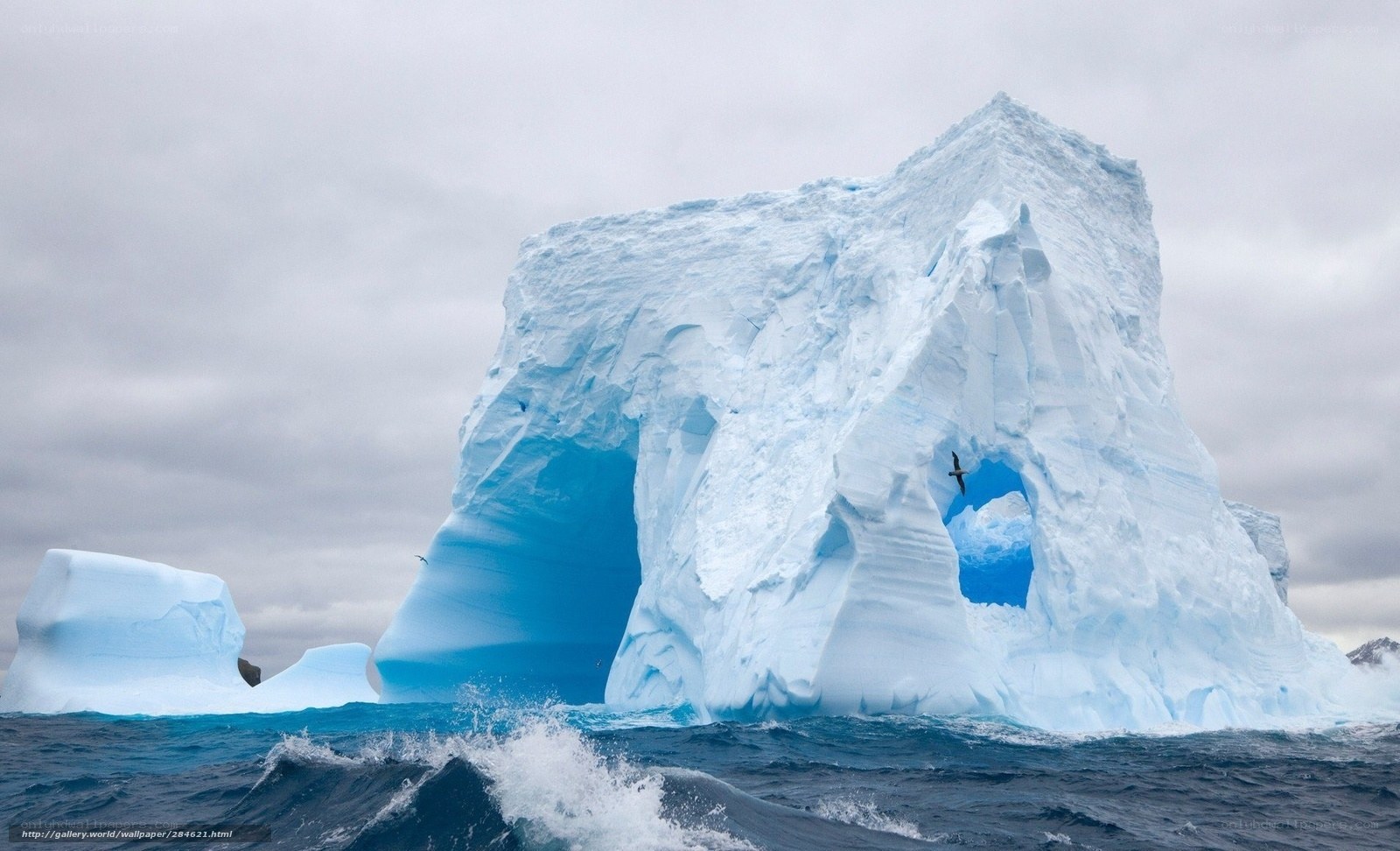 Iceberg with hole in ocean