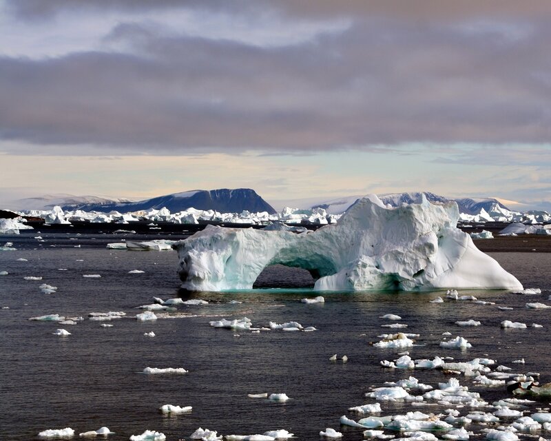 Iceberg with natural arch in polar waters