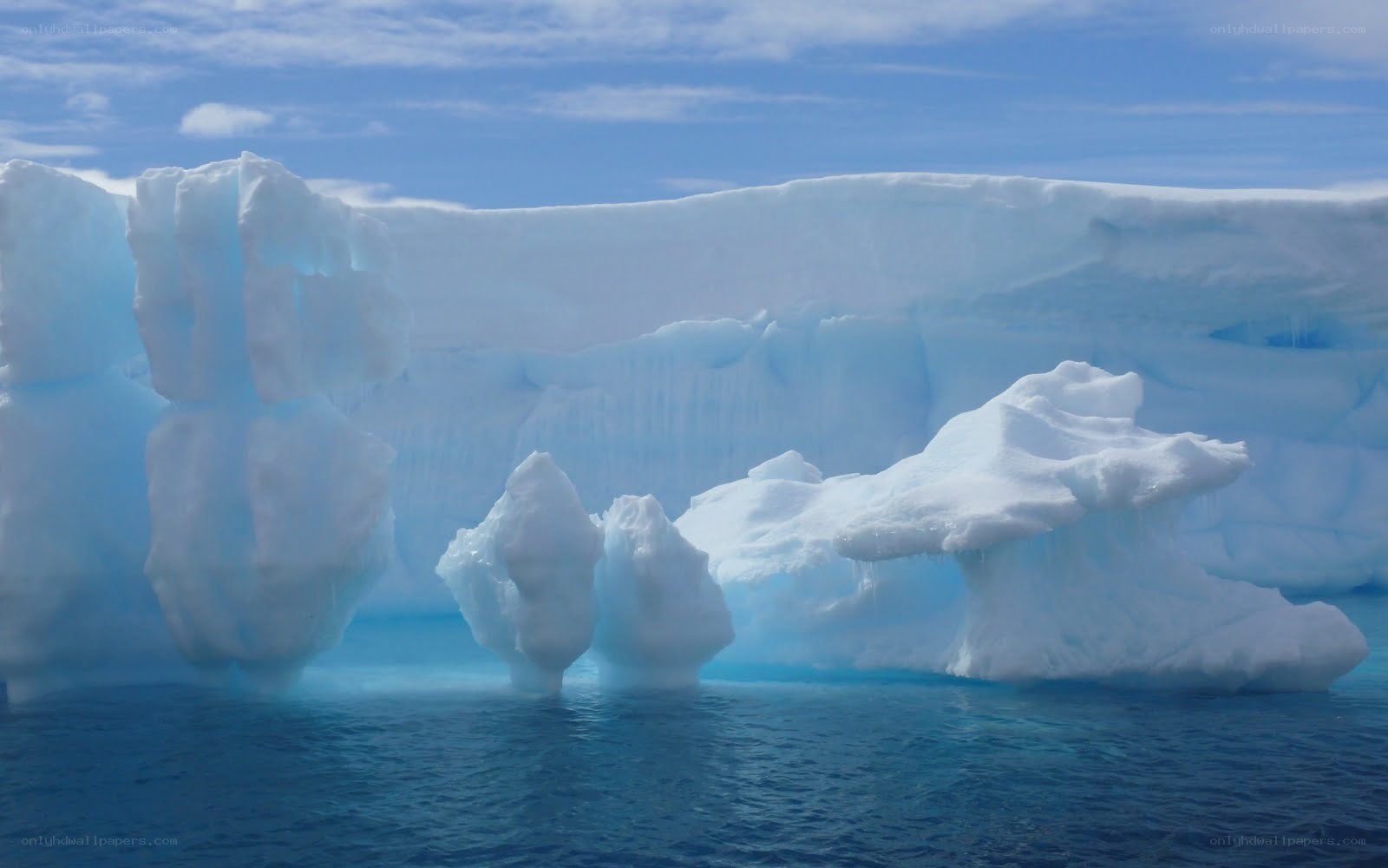 Icebergs floating in blue water