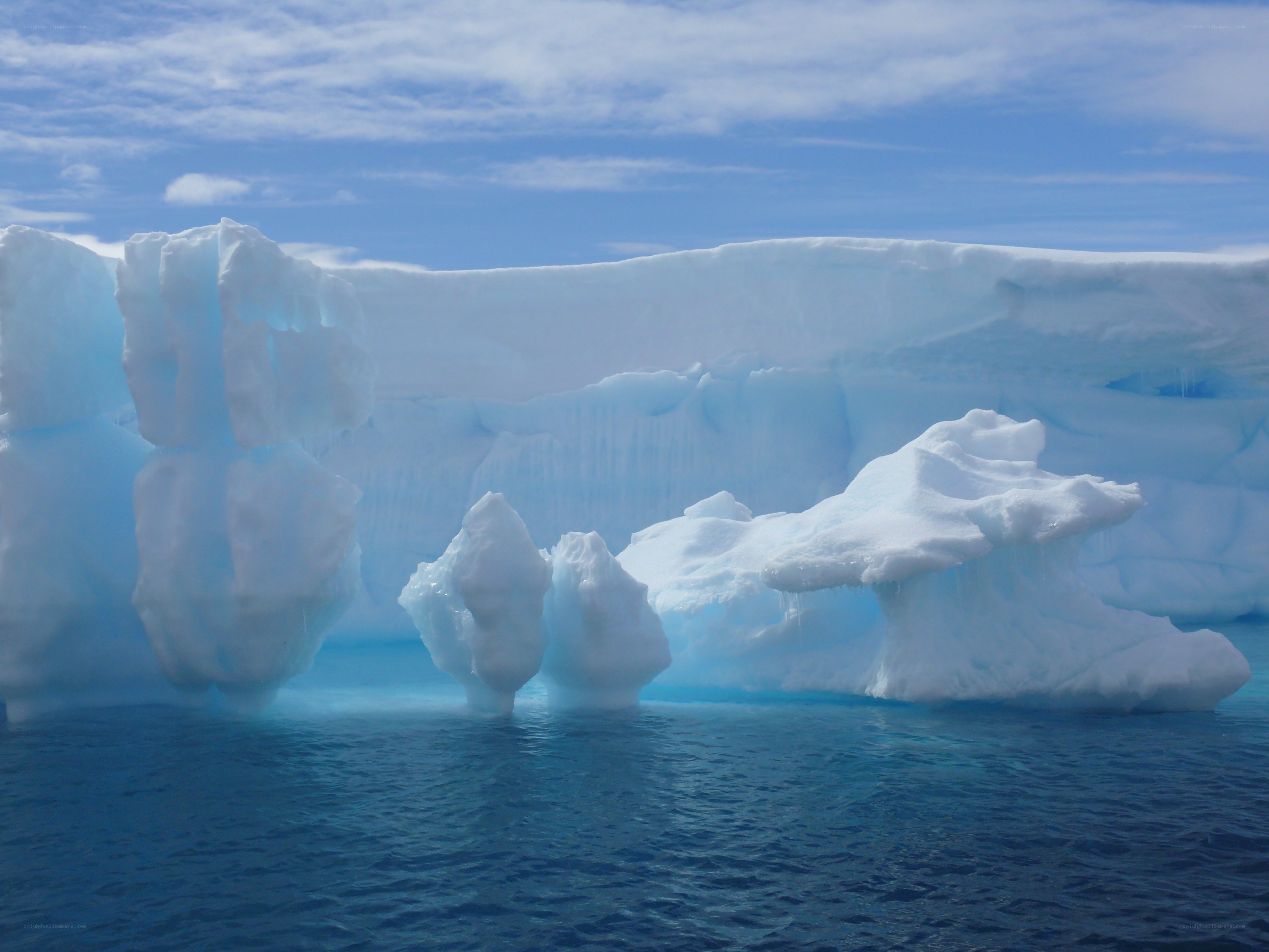 Icebergs floating in blue water