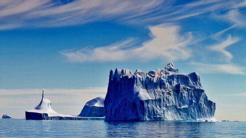 Icebergs floating in calm waters