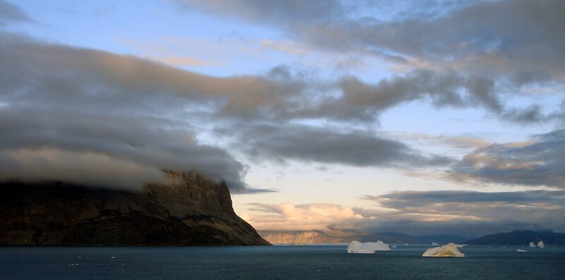 Icebergs in a fjord at dusk