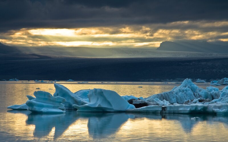 Icebergs in a Lagoon — Blue, Dramatic, Sunset, Photograph