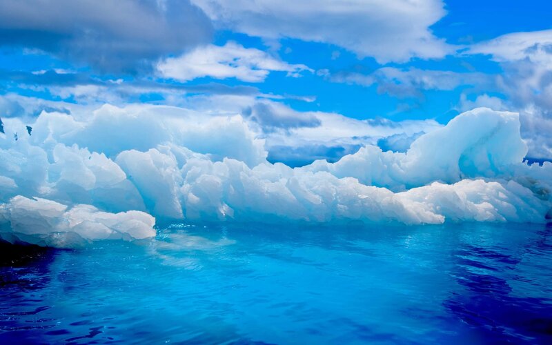 Icebergs in Blue Water — Serene, Afternoon, Photograph, Clouds, Sky