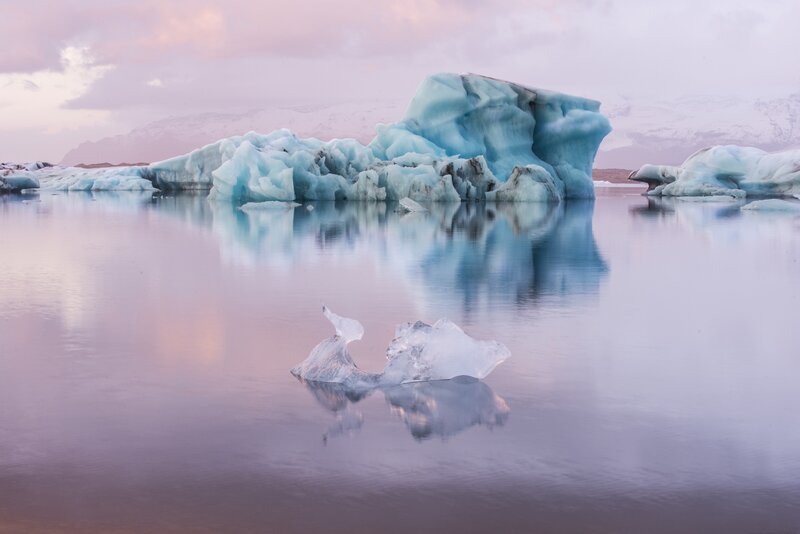 Icebergs in Calm Water — Blue, Serene, Sunset, Photograph, Mountains