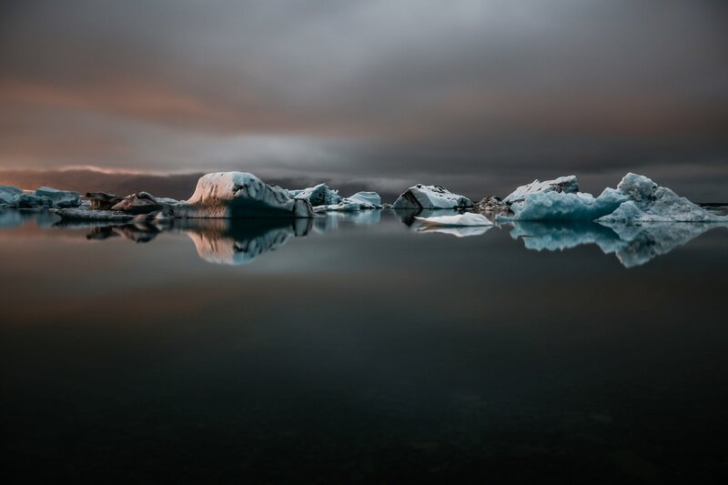 Icebergs in Calm Water — Blue, Serene, Sunset, Photograph, Sky, Clouds