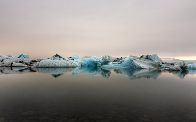 Icebergs in Calm Water — Blue, Serene, Sunset, Photograph, Sky
