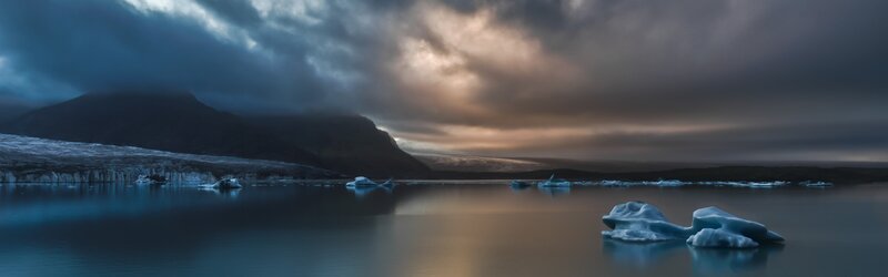 Icebergs in Glacial Lagoon — Blue, Dramatic, Sunset, Photograph, Mountain, Glacier, Clouds, Gray, Brown