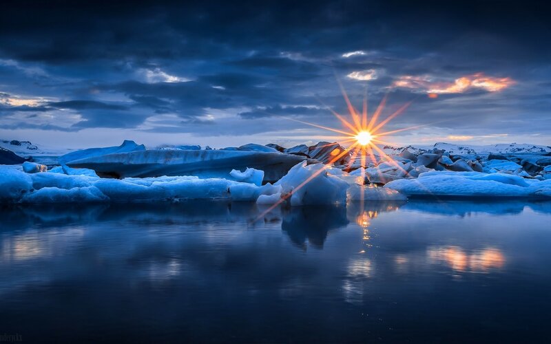 Icebergs in Glacial Lagoon — Blue, Dramatic, Sunset, Photograph, Sun, Clouds