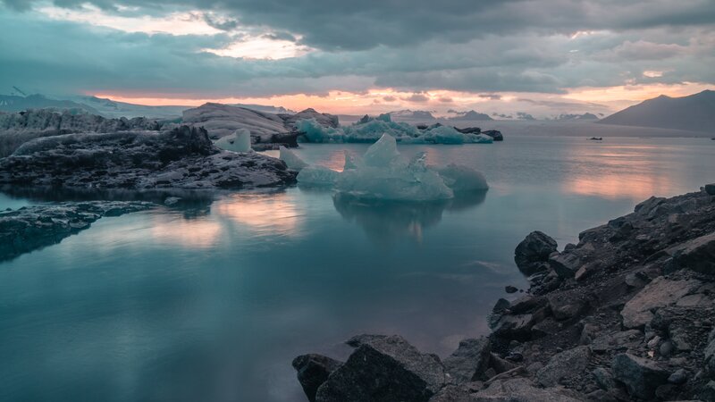 Icebergs in Glacial Lagoon — Blue, Serene, Sunset, Photograph, Glacier, Mountains, Water