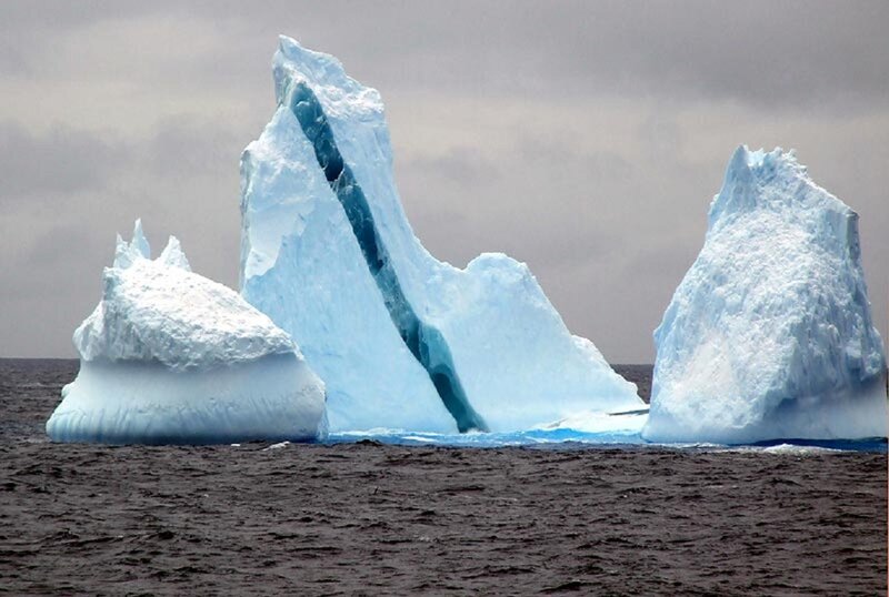 Icebergs in Ocean — Blue, Dramatic, Photograph, Sky