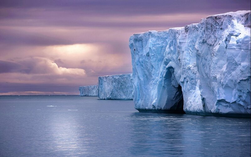 Icebergs in Ocean — Blue, Dramatic, Sunset, Photograph, Clouds