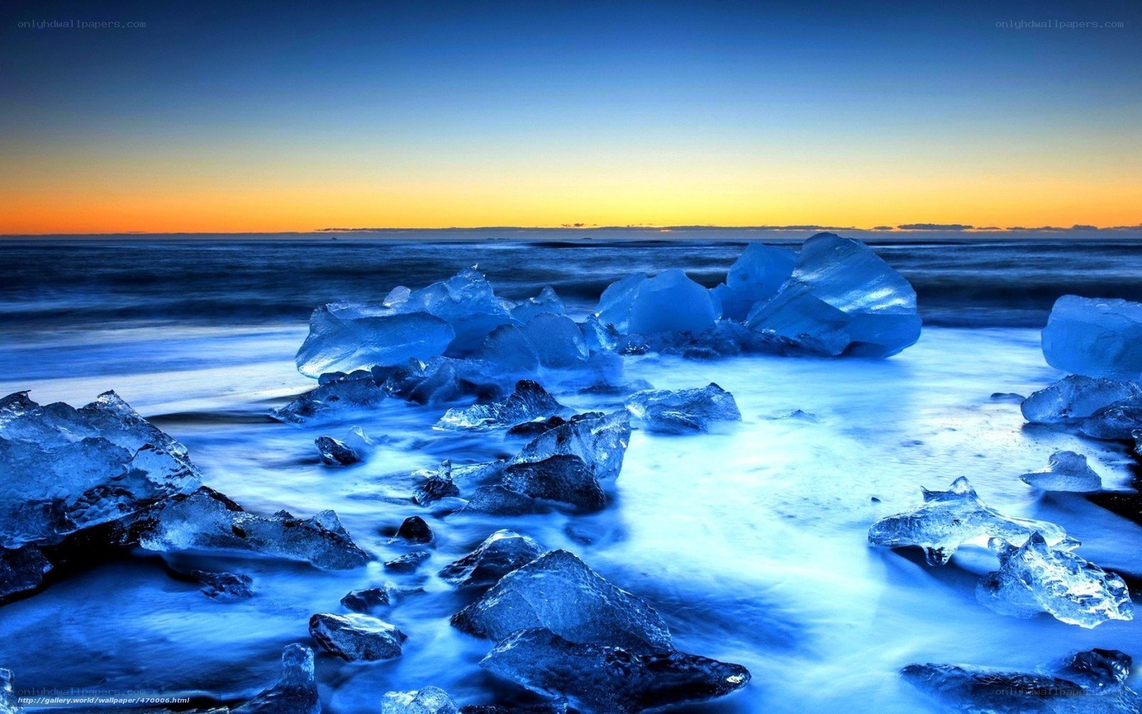 icebergs on a beach at sunset
