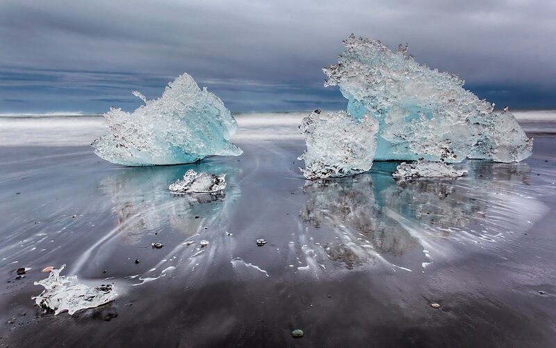 Icebergs on a black sand beach