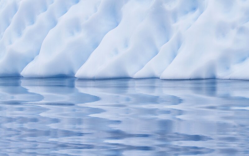 Icebergs reflecting in calm water