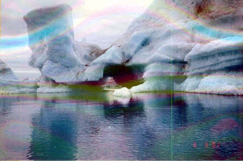 Icebergs with rainbow reflections