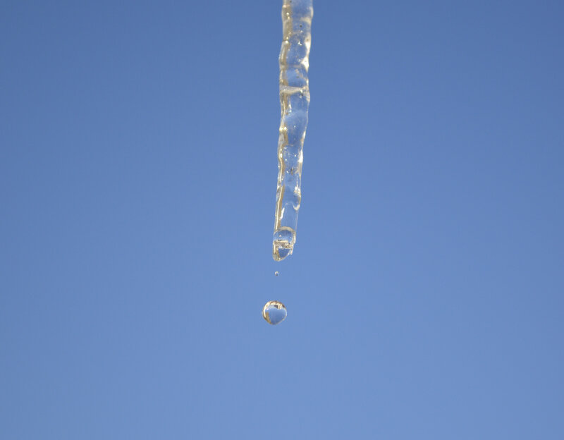 Icicle Melting Against Sky