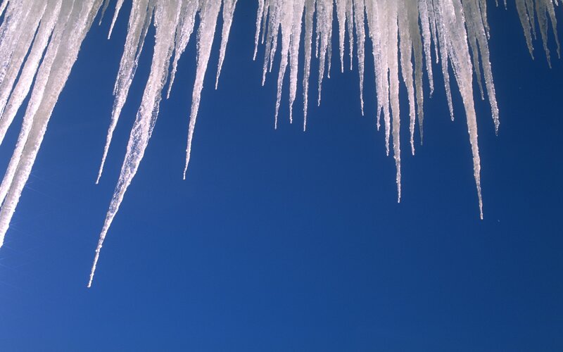 Icicles against blue sky
