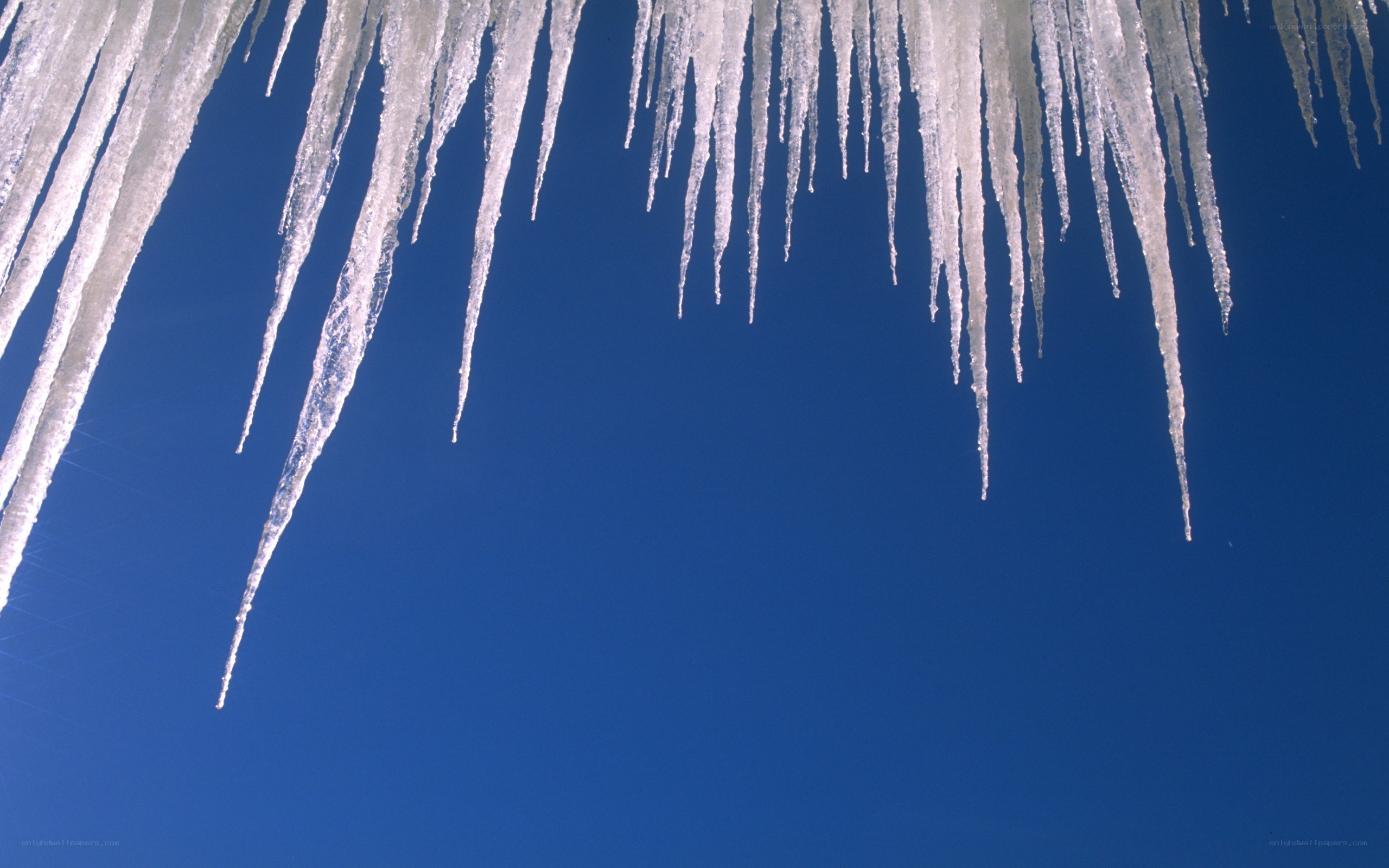 Icicles against blue sky