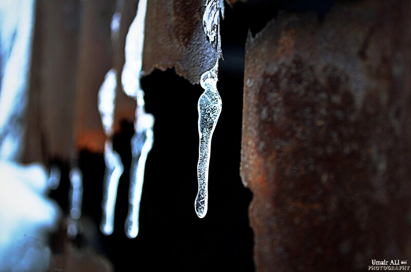 Icicles hanging from rusty metal