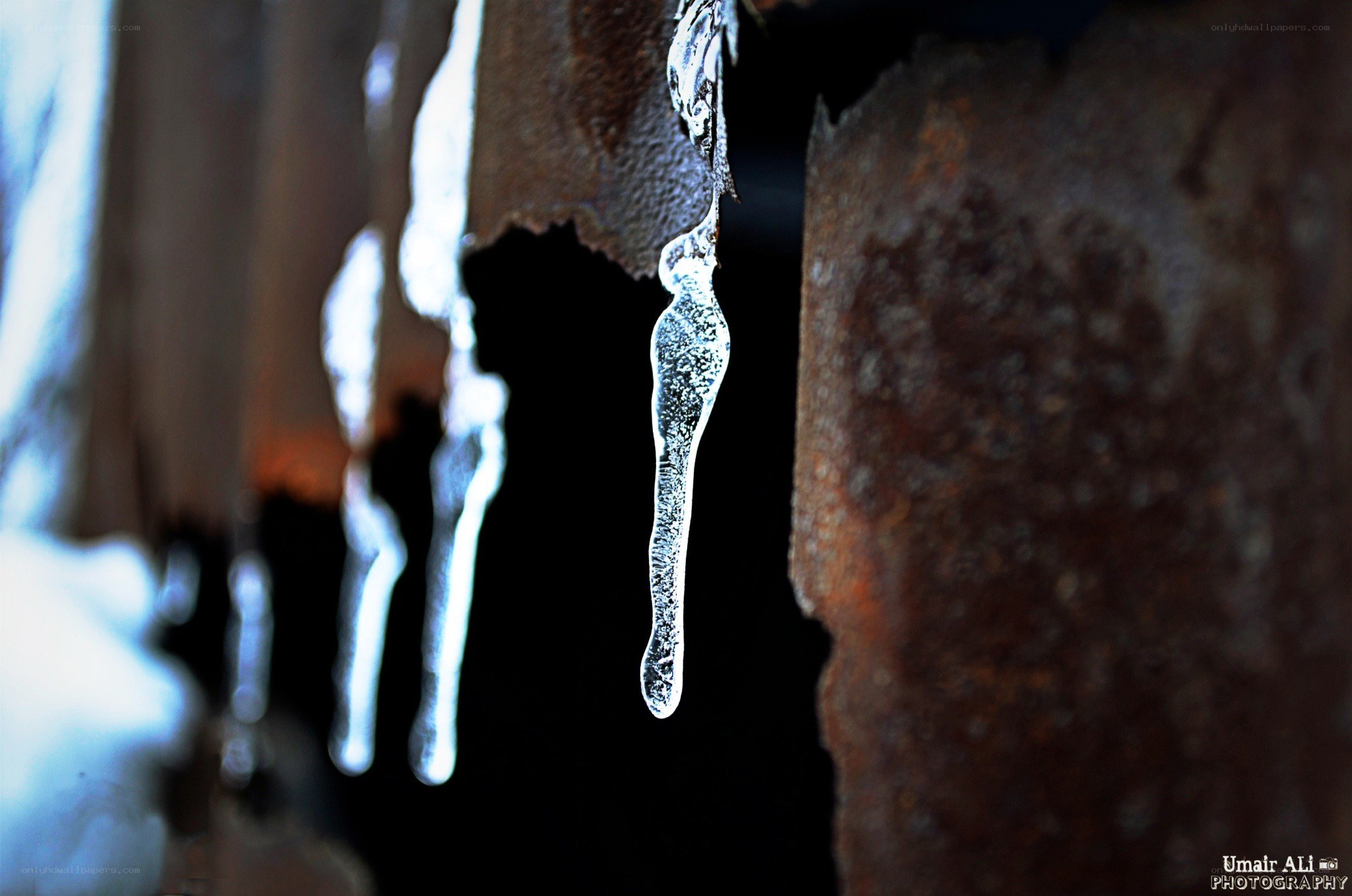 Icicles hanging from rusty metal