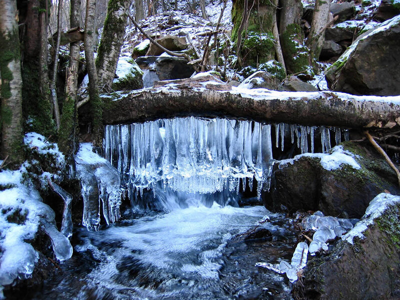 Icicles hanging over a stream