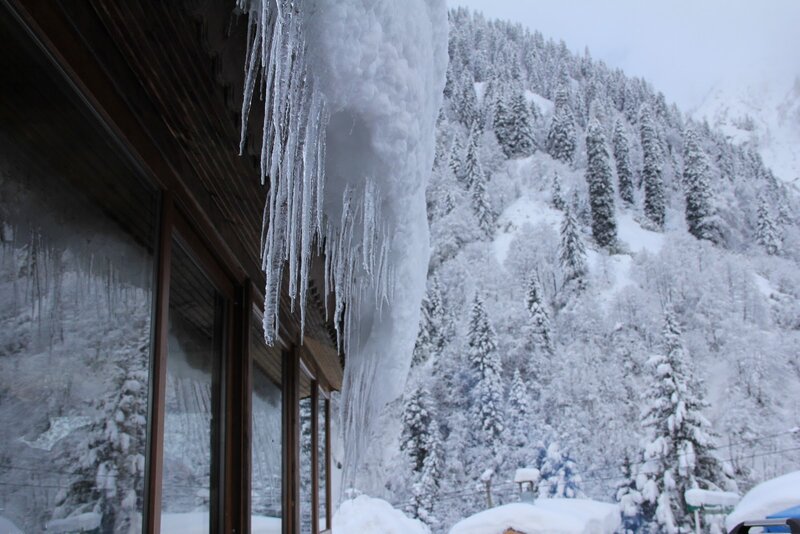 Icicles on a snowy mountain cabin