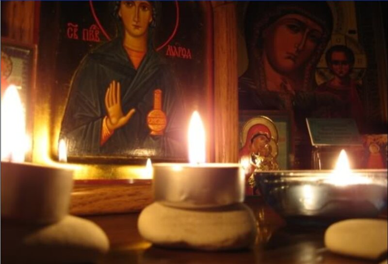 Icons and candles in prayer