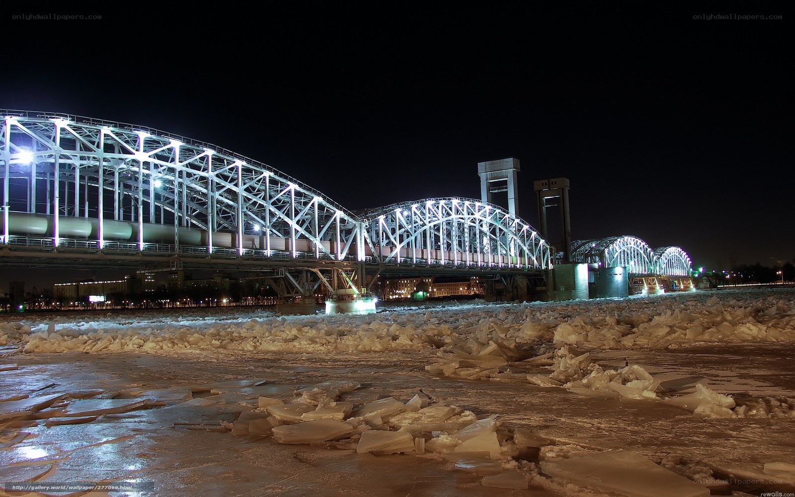 Icy river bridge at night